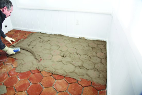 He fills the joints in the usual way, grouting about 20 square feet at a time.