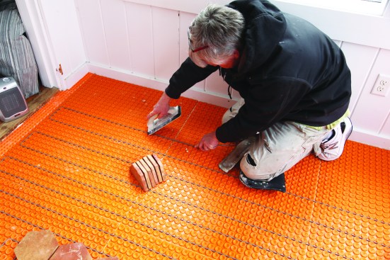 Wire for the Ditra- Heat system snaps into the raised studs on the membrane.