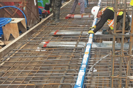 The Isokorb thermal break from Schöck creates an insulated structural connection between a balcony and the main floor slab of the building. The engineered connection is installed before concrete is poured, and it’s integrated into the rebar mat of the slab.