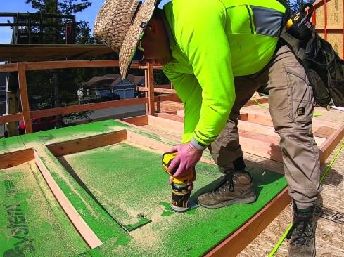 …sheathing over window and door openings and routing them out afterward (above).
