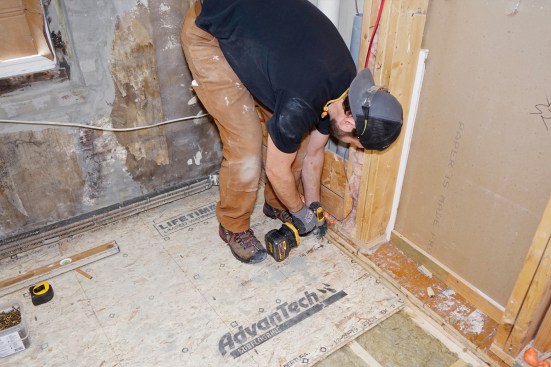 The subfloor is fastened down to the floor framing with 2 1/2-inch GRK screws (above).