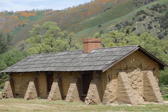 Rear elevation of the Orderlies’ Quarters (previously referred to as the “Soldiers’ Quarters”) as viewed from south. The structure is state of “arrested decay”—adobe buttresses were placed around an exterior wall in the 1950s to stabilize it until it could be fully preserved.