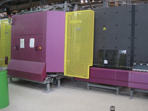 The glass panes and spacer frames are aligned and sent into a chamber. Air is evacuated and replaced with argon. The assembly is then pressed together leaving argon between the sheets of glass.