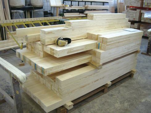 Blanks made from laminated layers of finger-jointed wood await processing.
