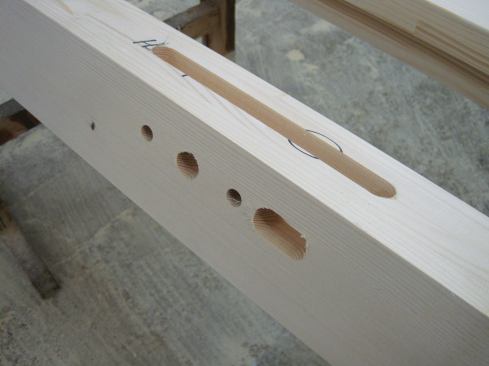 A computer-driven machine locates and cuts the hardware mortises. Pilot holes are also drilled for certain hardware.
