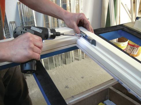 After all surfaces of the frame are finished, hardware is applied by a single person.