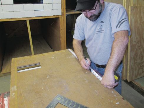 When the rack was full, I decided that it would be best and cleanest to store and transport the shingles in their original boxes. I came up with a quick, easy way to put them back. First I measured the width of the shingle box and marked that measurement on my table, subtracting 1/2 inch for clearance. I then sorted the stained shingles into three sizes.