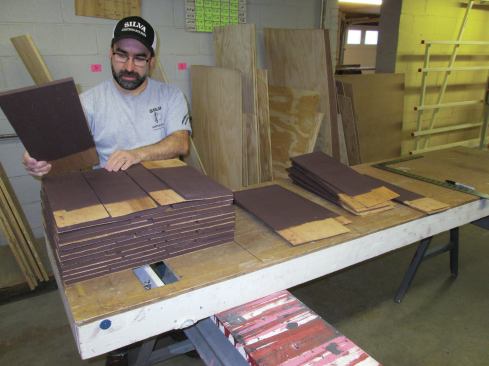 I then sorted the stained shingles into three sizes. Using the marks on the table, I stacked rows of shingles, taking the appropriate sizes from the sorted piles and alternating the butts on each row to keep the stack straight and square.