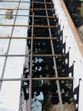 We cut the inner panels lower to create a turned-down curb around the perimeter. A 1-foot-by-1-foot rebar grid supported the heavy weight of the pool; vertical rebar couldn't be used because of the ledge below.
