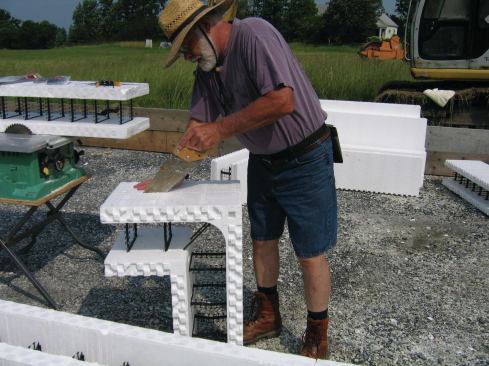 The blocks we used (rewardwalls.com) were 16 inches high and the bottom course was ripped to 8 inches high, yielding—with a full block on top—an overall height of 24 inches.