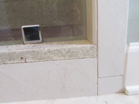 A close look at the shower revealed a number of potential problems: cracks along the corners of the curb ...