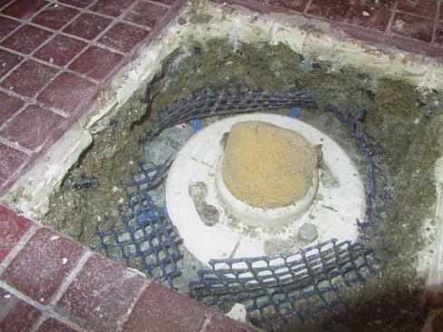 We found two obvious problems right away: First, the Oatey (oatey.com) clamp ring was installed so that the weep holes were facing the wrong way. The slots across the white clamp ring are weep holes that should be facing down.