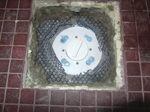 We bought the matching Sioux Chief clamp ring, and used NobleSealant 150 to glue the liner to the drain body. The cutouts for the bolts in the existing liner were pretty big, so we used a generous amount of sealant (the blue goop in the photo) around those. But we were careful not to clog the weep holes and slots. Keeping those open was critical to the job.