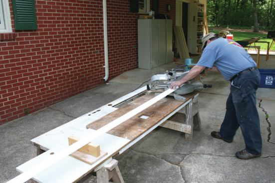 My work station is an old door on a couple of sawhorses. I'll put a piece of plywood on top to set my sliding compund miter saw on. Note the simple material support on the left side.