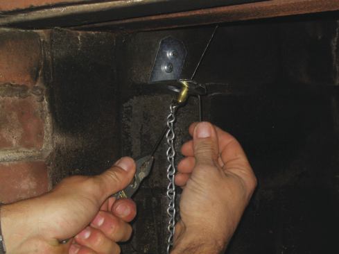 After you feed the damper control cable through the retainer bracket and position the stop fitting, pull on the cable with pliers until the top-sealing damper closes. Tighten the set screw on the stop fitting to lock it on the cable.