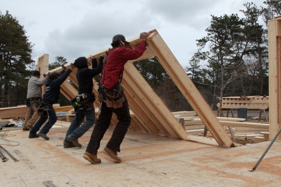 A coordinated effort by the crew makes raising most walls quick and easy. A telehandler can be used to lift the heaviest walls.