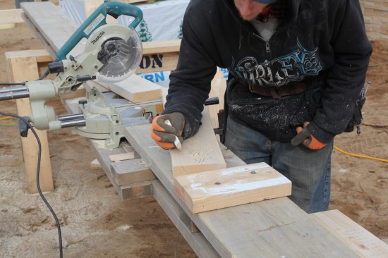 As each piece is cut to length, it is labeled with the size and what the piece is. Then it is put in a stack with other matching pieces and crossed off the list.