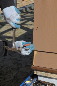 After driving the nail to secure the corner, always  set the nail flush with the surface of the shingle.