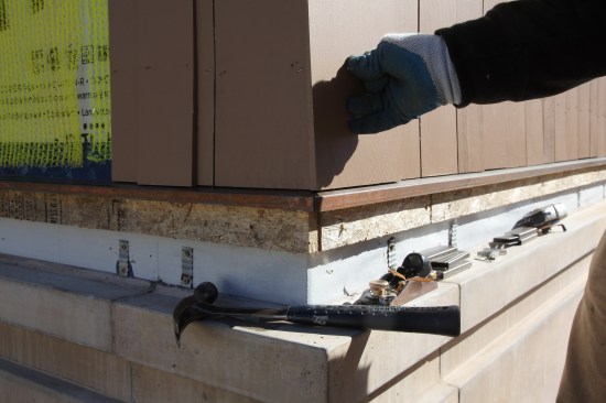 For the outer layer on the bottom course, hold the shingle in place making sure that the clearance at the bottom of the shingle is even with the shingles on the starter course.