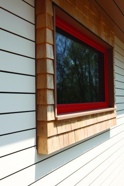 Transitions between the two types of siding have to be carefully detailed to channel water away from both surfaces.