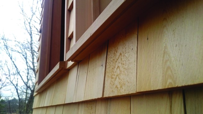 Grooves on the bottom edge of the window sill let water drip off instead of following the contour of the sill back to the siding.