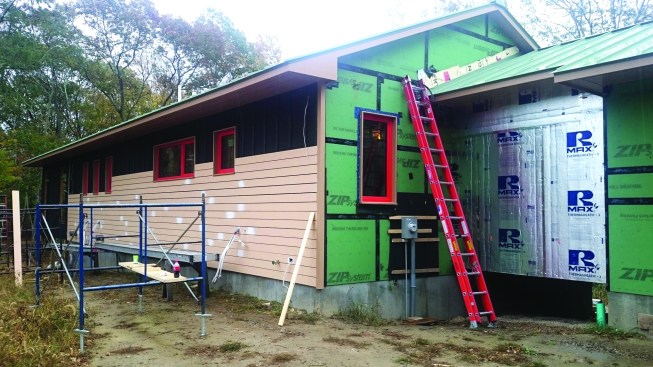 The horizontal siding nails to the strapping with gaps for ventilation between the boards. Note that the wide overhangs on the roof protect much of the siding and the windows from water.
