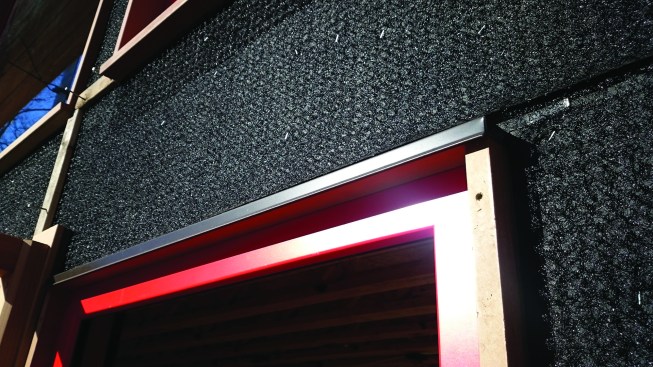 Certain wall areas are shingled in cedar for a visual accent. Rainscreen mesh applied over the building paper provides drainage space behind the shingles.
