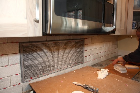 When the mural is complete, the subway tile then runs from the other side of the mural to the corner to complete the first backsplash wall.