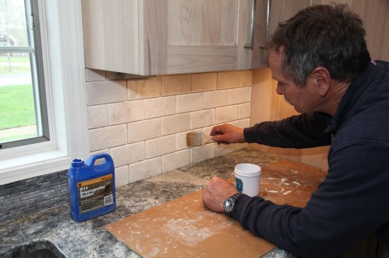 Before grouting, the author applies a coat of sealer to function as a grout release on the stone tile. 