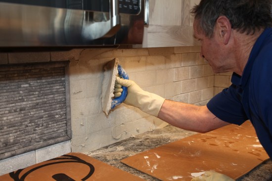 The grout goes onto the field tile in the usual fashion, applied with diagonal strokes in opposite directions until all the joints are filled. 