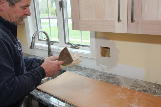 Thinset applied to the backside of the patch acts as the adhesive.