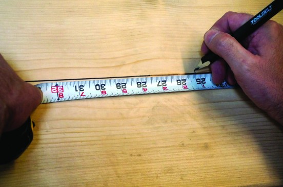 After determining the diagonal distance on a construction calculator, mark those measurements along the scribed line.