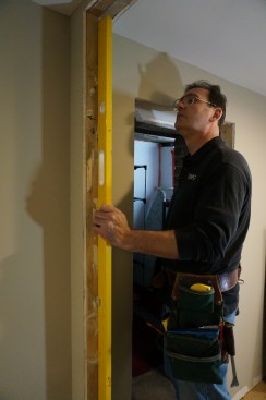 Using a long level check the jambs to make sure they are plumb and square to the opening.