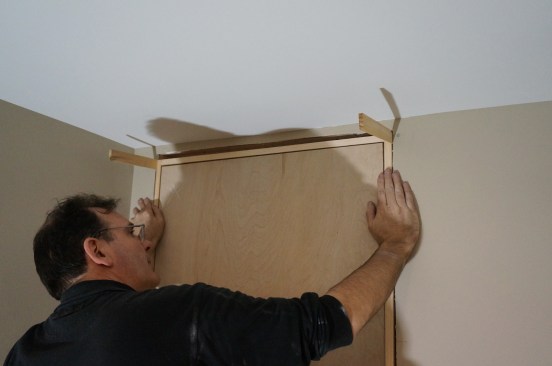 Set the door assembly in the opening and insert shims on either side of the head jamb. These shims hold the assembly in the opening without fasteners. Check to be sure the reveal is the same all around the door.