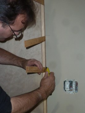 After nailing off the jambs, cut the shims off flush with the edge of the jambs using a utility knife or an oscillating tool.