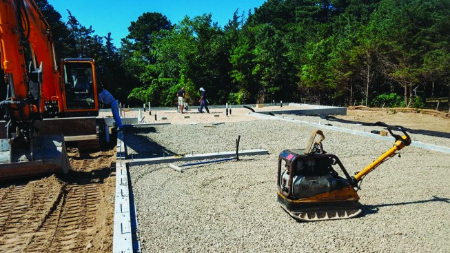 As with typical slab-on-grade construction, the next step was laying down and compacting a layer of crushed stone.