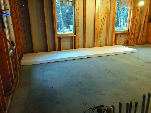 After the building had been dried in, the crew put down sheets of 4-inch EPS rigid foam insulation over the slab.