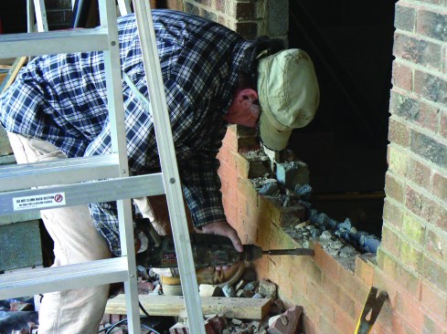 The author enlarges a window opening for the new door.