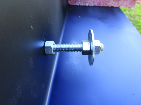 Bolts threaded onto the jambs form masonry anchors for the side jambs.