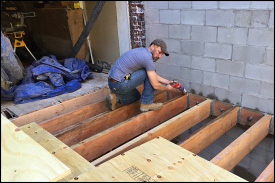 The addition’s parlor-level (second floor) 3x10 joists were flush framed to 3x10 ledgers. The ledgers were anchored to the block wall’s bond beams with two-part epoxy is injected into predrilled holes. Expansion bolts were inserted and then tightened it down. After a little while, the epoxy cured and the anchor connections were rock hard.