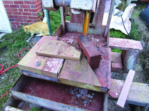 A site-built jig holds the brick at the correct 29-degree angle (based on a rise of 6 5/8 inches and a run of 12 inches) for cutting on the wet saw.