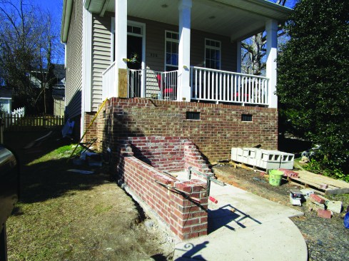 With the first angled brick placed, the author set up two lines to follow as he laid up the sloping side walls of the staircase.