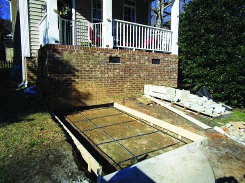 For comfort and layout simplicity, they set the tread depth at 12 inches. For nine 12-inch treads plus a 12-inch column on each side, the forms extended 120 inches from the porch wall to the concrete walkway, which was cut square to the slab.