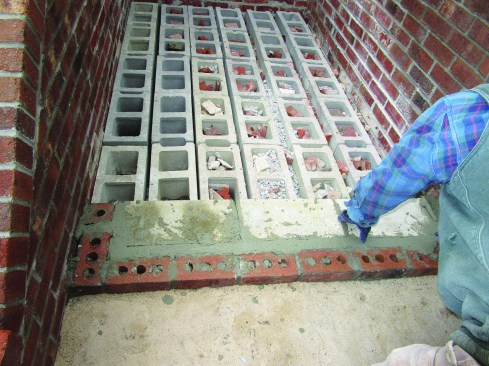 The author began each step with a 2 5/8-inch-high course of stretchers (bricks laid with their longest edge facing out), then used 2 1/4-inchhigh concrete cap blocks for fill so that the first layer of each step was 13 1/2 inches deep.