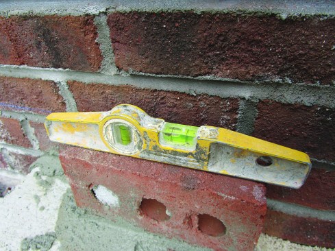 The second layer of each step consisted of rowlocks. Keeping a quarter of a bubble outside the line on the level ensured that the rowlocks would be pitched to drain surface water properly.