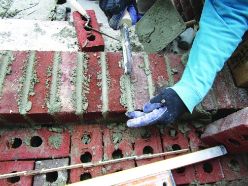 He finished the joints with a sled runner, which packs the mortar tight and leaves a straight joint with a concave profile.