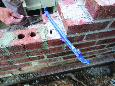 An 8-inch line stretcher hooks over the bricks to hold the other end.