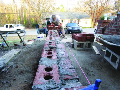 Tension on the twine holds the stretcher in place while the next course is laid.