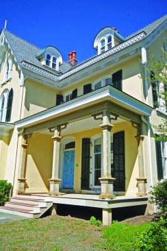 Finishing up, the porch trim is to be painted white, nicely offsetting the home’s light yellow stucco cladding and the dark green (almost black) shutters.