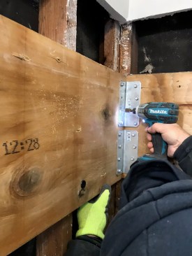 To support the corner of the house while the foundation was bing repaired, the crew first lagged LVLs into the wall studs. 